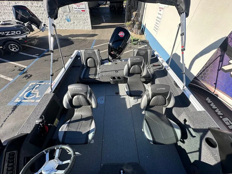 Slide: The Image of 2025 Lund 1775 Impact XS Sport boat interior with seating and steering wheel. - 10