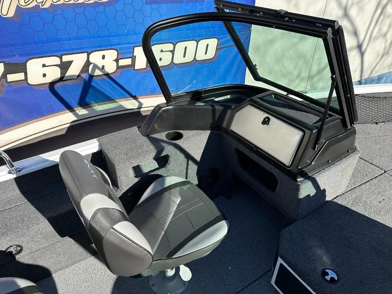 Slide: The Image of 2025 Lund 1775 Impact XS Sport boat interior with seating and windshield. - 11