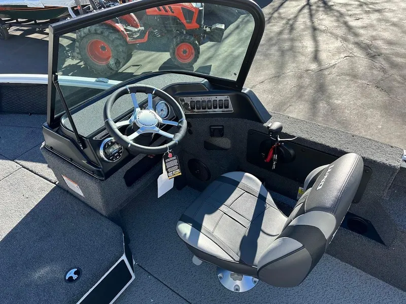 Slide: The Image of 2025 Lund 1775 Impact XS Sport boat interior with steering wheel and seat. - 12