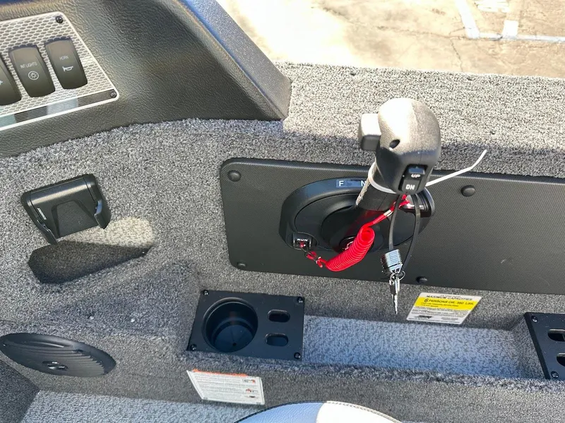 Slide: The Image of 2025 Lund 1775 Impact XS Sport boat interior with control panel and throttle. - 16
