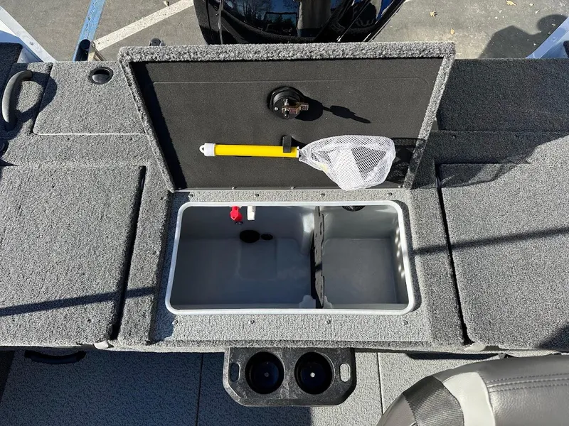 Slide: The Image of 2025 Lund 1775 Impact XS Sport boat interior with storage compartment and fishing net. - 18