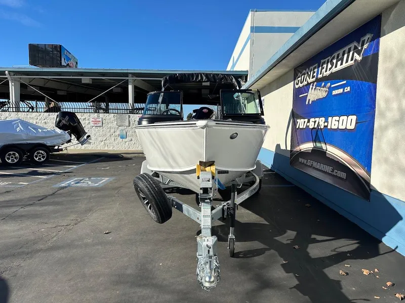 Slide: The Image of 2025 Lund 1775 Impact XS Sport boat on trailer in dealership lot. - 2