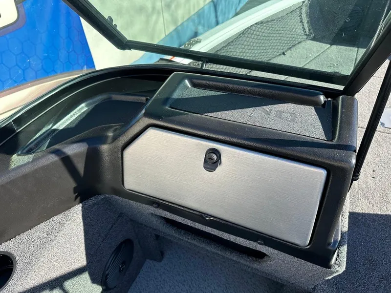 Slide: The Image of 2025 Lund 1775 Impact XS Sport boat dashboard with storage compartment. - 20