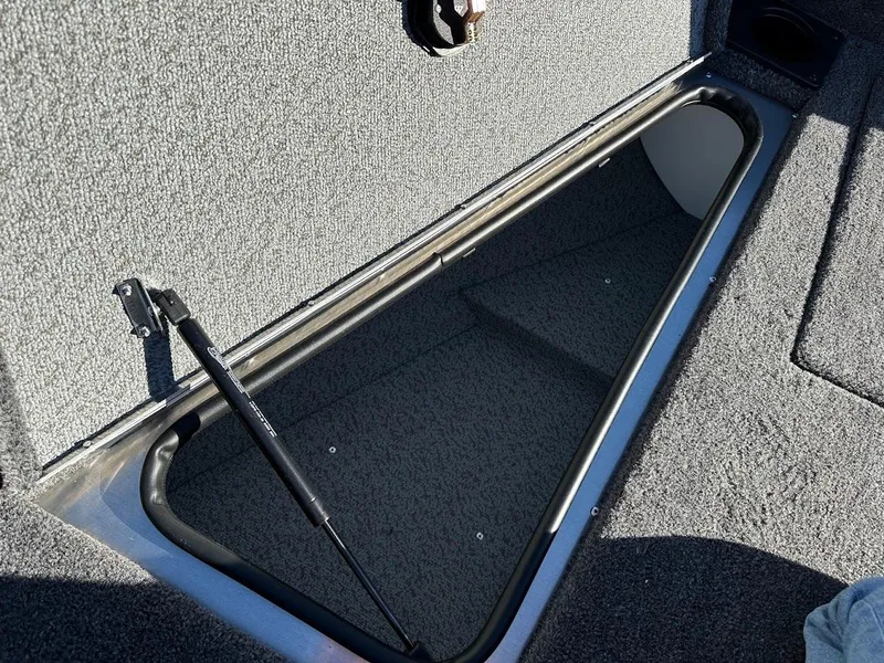Slide: The Image of Open storage compartment in 2025 Lund 1775 Impact XS Sport boat. - 27