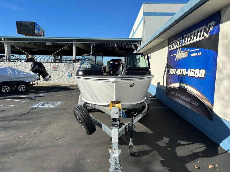 Slide: The Image of 2025 Lund 1775 Impact XS Sport boat on trailer at dealership. - 3