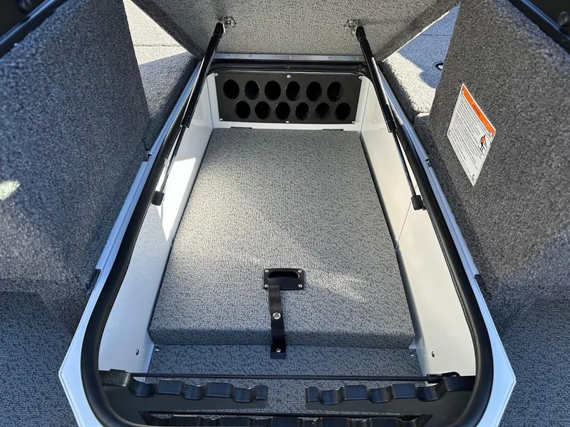 Slide: The Image of 2025 Lund 1775 Impact XS Sport boat storage compartment with rod holders. - 30