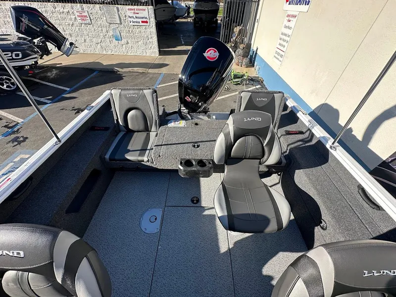 Slide: The Image of 2025 Lund 1775 Impact XS Sport boat interior with seating and motor. - 9