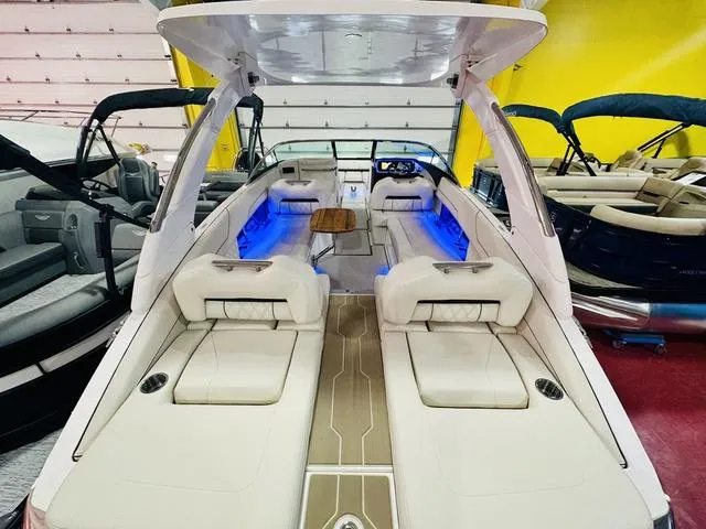 Slide: The Image of 2025 Regal LS6 boat interior with blue LED lighting and luxurious seating. - 11