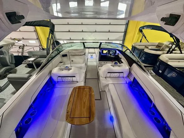 Slide: The Image of 2025 Regal LS6 boat interior with blue LED lighting and sleek seating. - 12