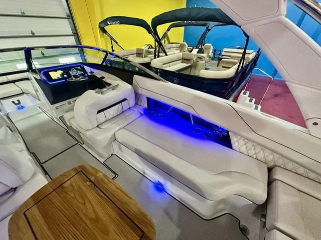 Slide: The Image of 2025 Regal LS6 boat interior with white seating and blue LED lighting. - 13