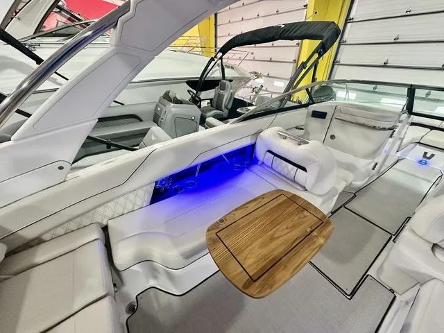 Slide: The Image of Luxurious 2025 Regal LS6 boat interior with elegant seating and ambient blue lighting. - 14