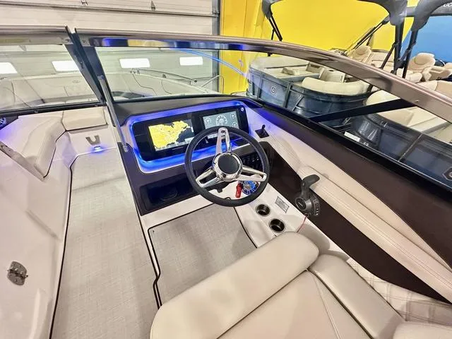 Slide: The Image of 2025 Regal LS6 boat interior with modern dashboard and steering wheel. - 15