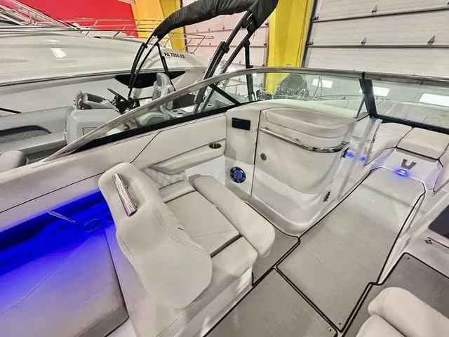 Slide: The Image of 2025 Regal LS6 boat interior with white seating and blue LED lighting. - 16