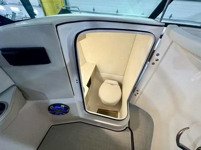 Slide: The Image of 2025 Regal LS6 boat interior with compact bathroom and modern amenities. - 17