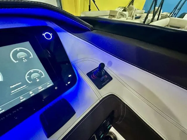 Slide: The Image of 2025 Regal LS6 boat dashboard with illuminated controls and touchscreen display. - 19