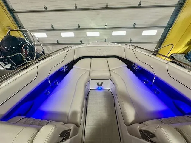 Slide: The Image of 2025 Regal LS6 boat interior with blue LED lighting and luxurious seating. - 22