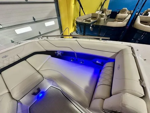 Slide: The Image of Luxurious 2025 Regal LS6 boat interior with blue LED lighting and plush seating. - 23