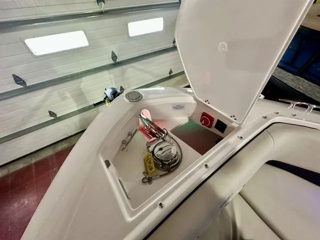 Slide: The Image of 2025 Regal LS6 boat storage compartment with tools and accessories. - 24
