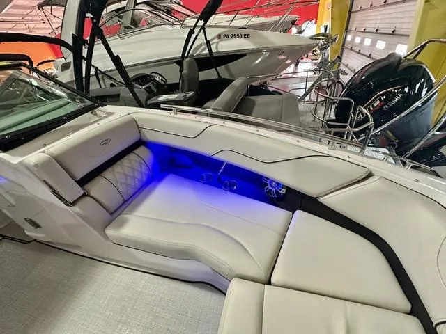 Slide: The Image of 2025 Regal LS6 boat interior with luxurious seating and blue LED lighting. - 25