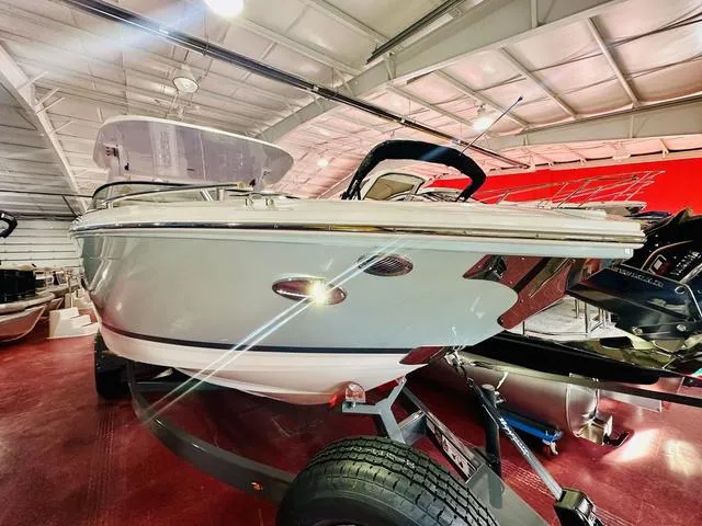 Slide: The Image of 2025 Regal LS6 boat in showroom, sleek design, on trailer. - 3