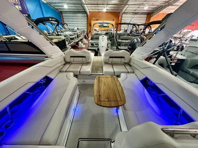 Slide: The Image of Luxurious 2025 Regal LS6 boat interior with blue LED lighting and wooden table. - 30