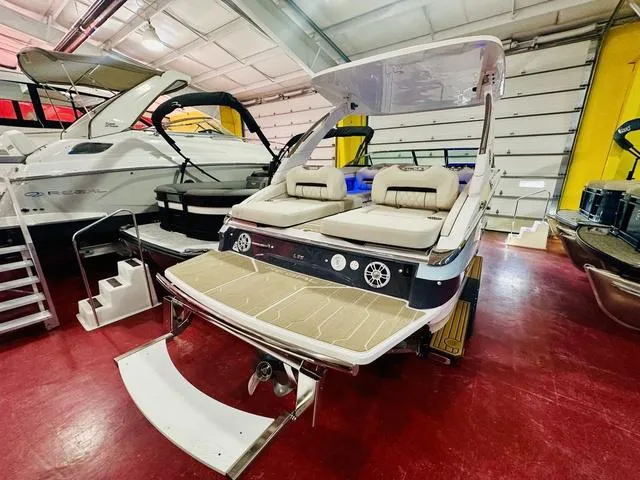Slide: The Image of 2025 Regal LS6 boat in showroom, featuring spacious seating and modern design. - 9