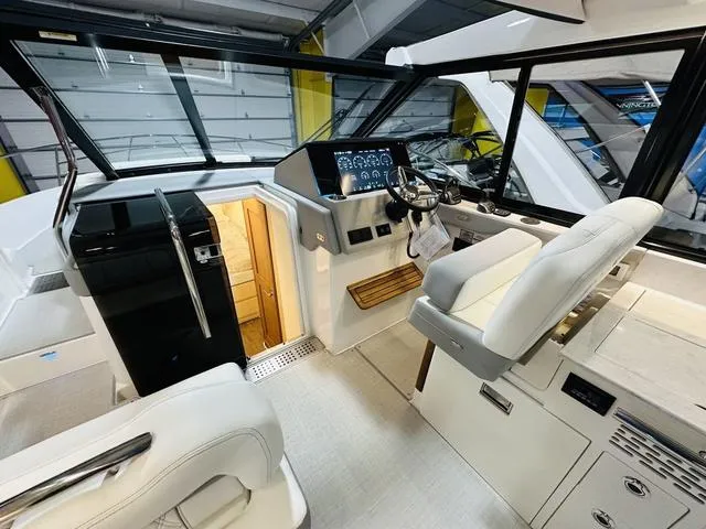 Slide: The Image of Interior of 2025 Regal 36 Grande Coupe yacht, featuring modern helm and seating. - 12