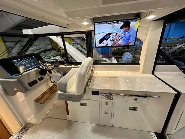 Slide: The Image of 2025 Regal 36 Grande Coupe helm with modern dashboard and comfortable seating. - 13