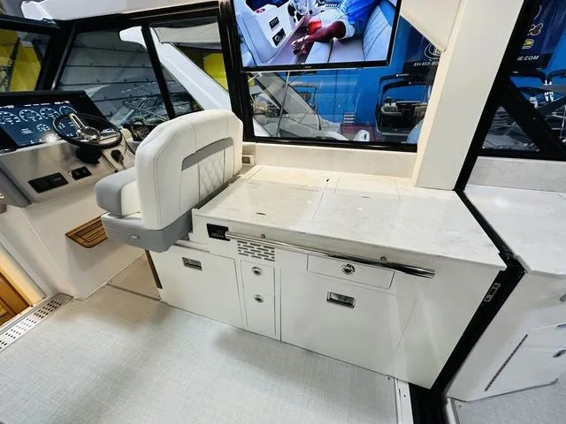 Slide: The Image of Interior of 2025 Regal 36 Grande Coupe, featuring helm and seating area. - 14