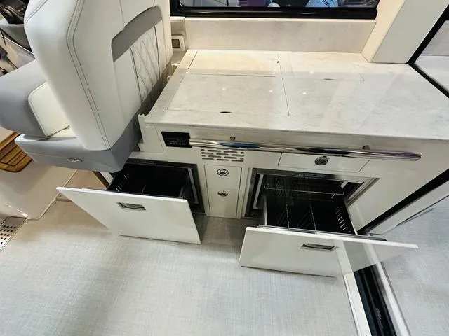 Slide: The Image of Interior of 2025 Regal 36 Grande Coupe with open storage compartments. - 15