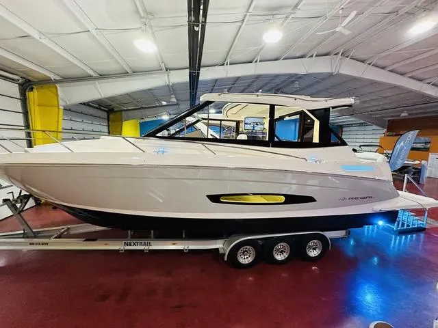 Slide: The Image of 2025 Regal 36 Grande Coupe boat displayed indoors on a trailer. - 16