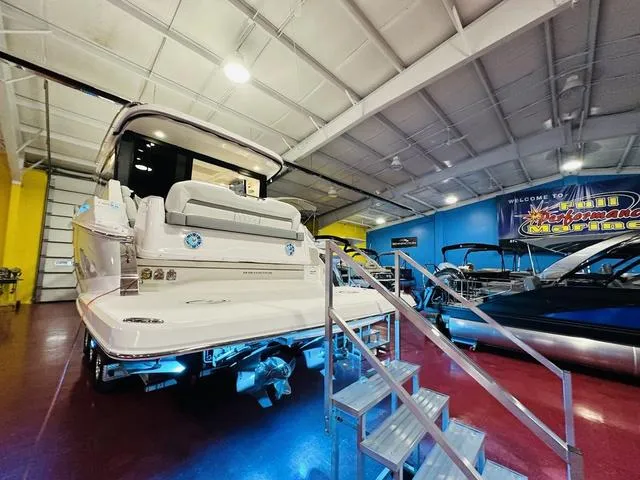 Slide: The Image of 2025 Regal 36 Grande Coupe yacht displayed in showroom with vibrant lighting. - 19