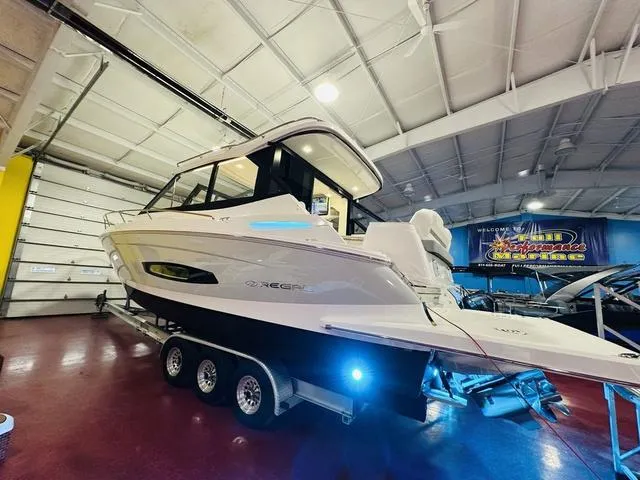 Slide: The Image of 2025 Regal 36 Grande Coupe boat on trailer in showroom. - 21