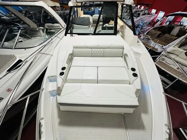 Slide: The Image of 2025 Regal 36 Grande Coupe luxury boat interior with white seating and sleek design. - 22