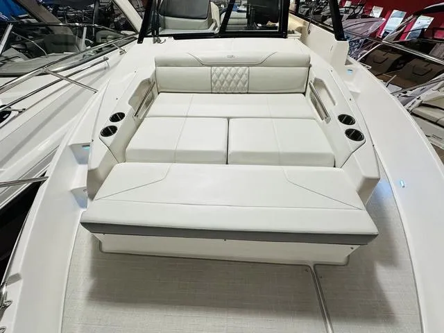 Slide: The Image of 2025 Regal 36 Grande Coupe boat interior with white seating and cup holders. - 23