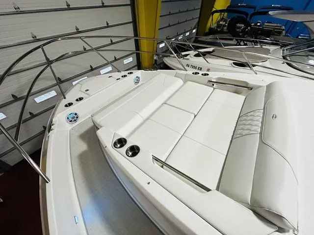 Slide: The Image of 2025 Regal 36 Grande Coupe boat with luxurious white seating and stainless steel railings. - 24