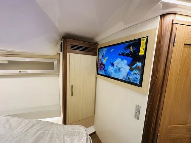 Slide: The Image of Interior of 2025 Regal 36 Grande Coupe with TV and modern wood finishes. - 28