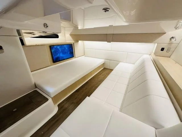 Slide: The Image of Luxurious interior of 2025 Regal 36 Grande Coupe yacht with modern seating and TV. - 30