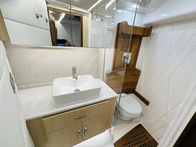 Slide: The Image of Luxurious bathroom in 2025 Regal 36 Grande Coupe yacht with modern fixtures. - 31