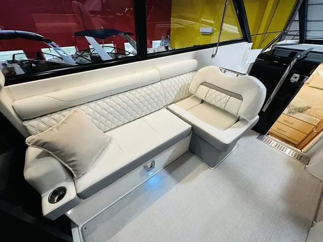 Slide: The Image of Luxurious seating area in 2025 Regal 36 Grande Coupe yacht interior. - 32