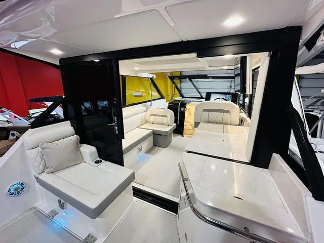 Slide: The Image of Luxurious interior of 2025 Regal 36 Grande Coupe yacht with modern seating and sleek design. - 5
