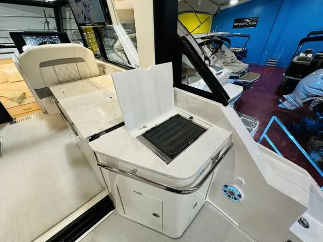 Slide: The Image of 2025 Regal 36 Grande Coupe interior with modern kitchenette and seating area. - 7