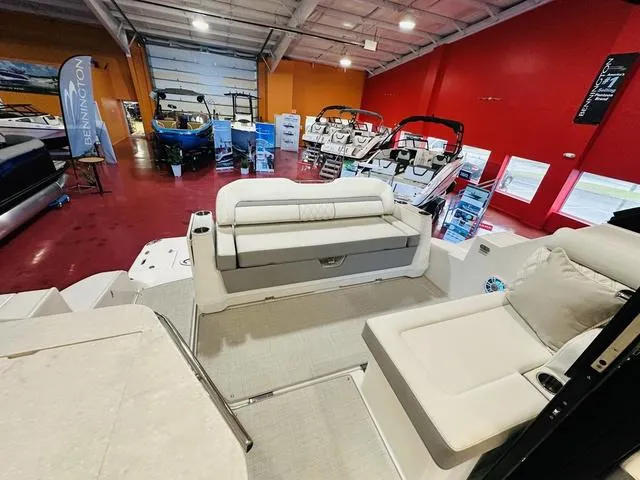 Slide: The Image of 2025 Regal 36 Grande Coupe interior in showroom with red walls and various boats. - 9