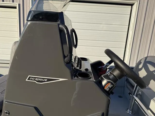 Slide: The Image of 2025 Avid 20 ROGUE CC boat console with steering wheel and controls. - 15