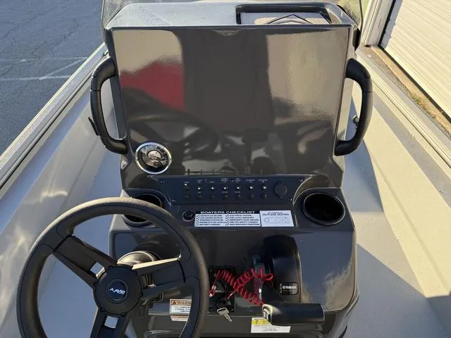 Slide: The Image of 2025 Avid 20 ROGUE CC boat console with steering wheel and controls. - 19