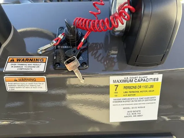 Slide: The Image of Avid 20 ROGUE CC 2025 boat dashboard with warning labels and ignition keys. - 21