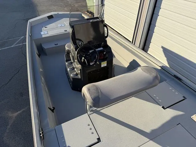 Slide: The Image of 2025 Avid 20 ROGUE CC boat interior with steering console and seating. - 23