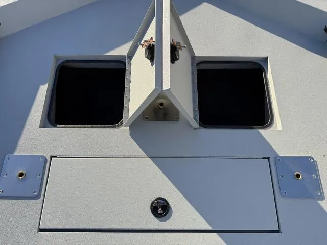 Slide: The Image of Avid 20 ROGUE CC 2025 boat storage compartments with open hatches. - 8