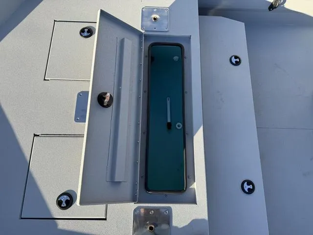 Slide: The Image of Avid 20 ROGUE CC 2025 boat storage compartments and hatch detail. - 9