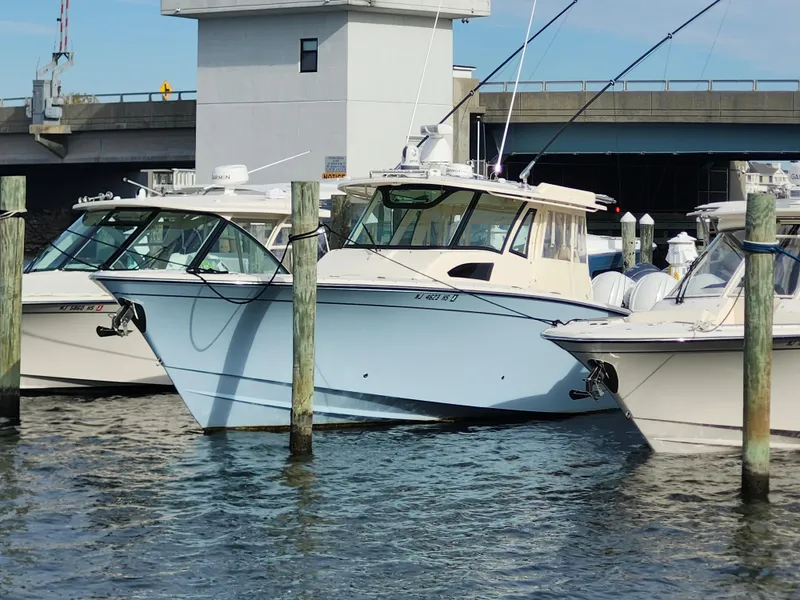 Slide: The Image of 2023 Grady-White Canyon 376 boat docked with triple outboard engines. - 13
